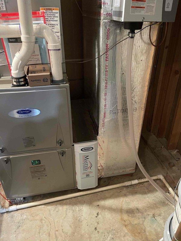Completed HVAC install warranty inspection in basement utility area. Verified proper installation of Carrier heating and cooling equipment with associated PVC drainage and ventilation piping, confirmed floor register placement and operation, and documented proper insulation installation in wall cavities. All components functioning as designed with no deficiencies noted.