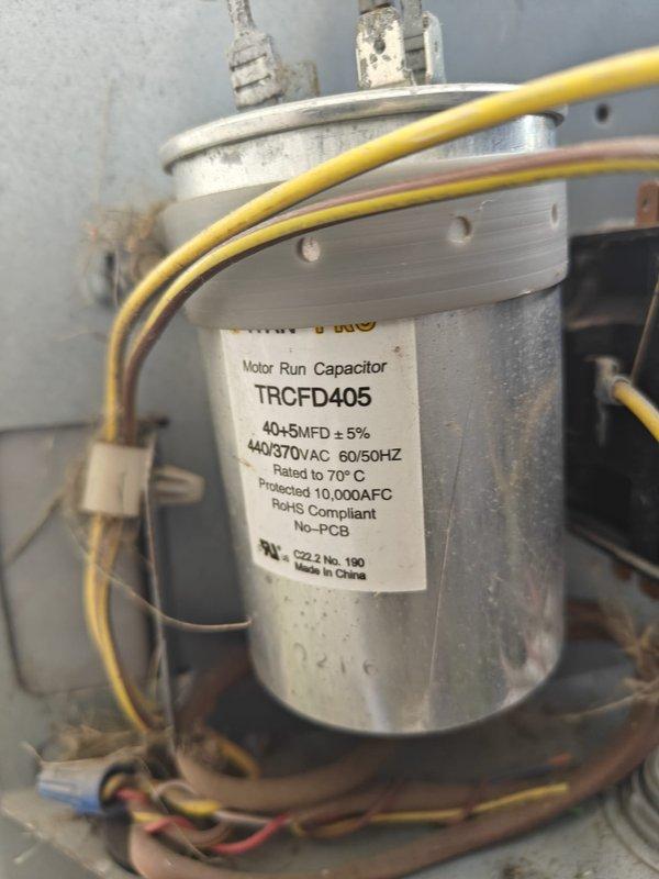 Completed routine cooling system maintenance on residential HVAC unit. Inspected dual-run capacitor (TRCFD405, 40+5 MFD, 440/370VAC) and verified proper electrical connections; capacitor operating within specifications with all terminals secure. Measured system temperatures and recorded suction line temperature of 53.8°F, indicating adequate refrigerant charge and proper system operation. Cleaned condenser coil and checked airflow across evaporator. All safety controls tested and functioning correctly. System operating efficiently with no deficiencies noted. Customer renewed preventative service agreement during visit.