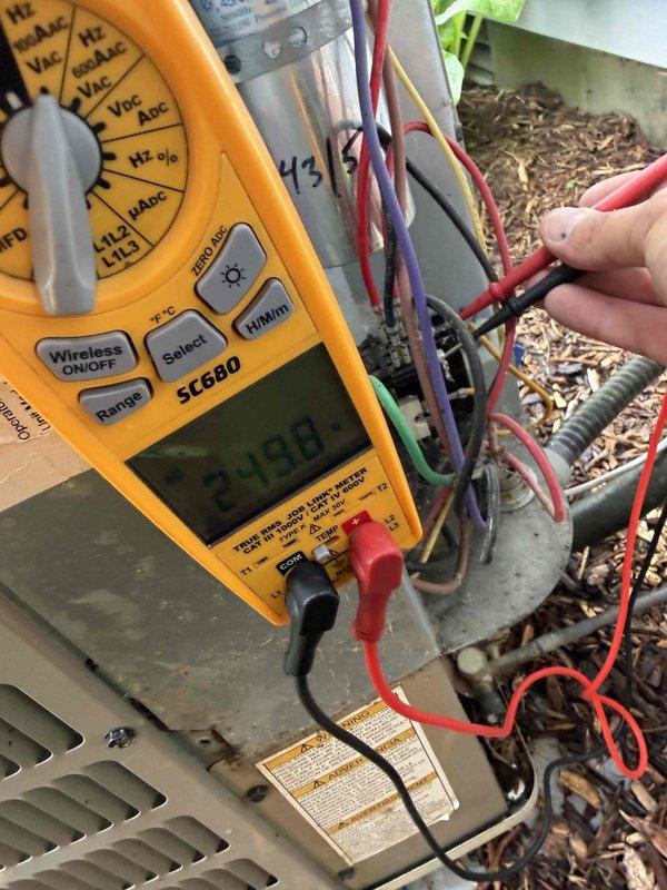 Completed complimentary air conditioning tune-up for new customer who received certificate through coloring contest promotion. Performed standard maintenance procedures on outdoor condensing unit including electrical diagnostics with multimeter showing 23.66V reading at terminals, inspected all wire connections and components, and cleaned condenser coil. Unit operating within normal parameters upon completion.