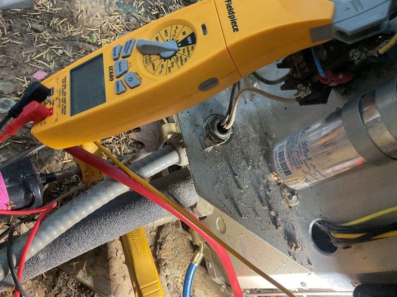 Completed comprehensive cooling maintenance on Trane HVAC system including inspection of furnace unit, air handler, and outdoor condensing unit. Performed electrical diagnostics using digital clamp meter, verified amperage readings at 64.1 amps, and inspected refrigerant line insulation for proper coverage. Checked condensate pump operation and drainage system functionality, ensuring all components operating within manufacturer specifications for optimal cooling season performance.