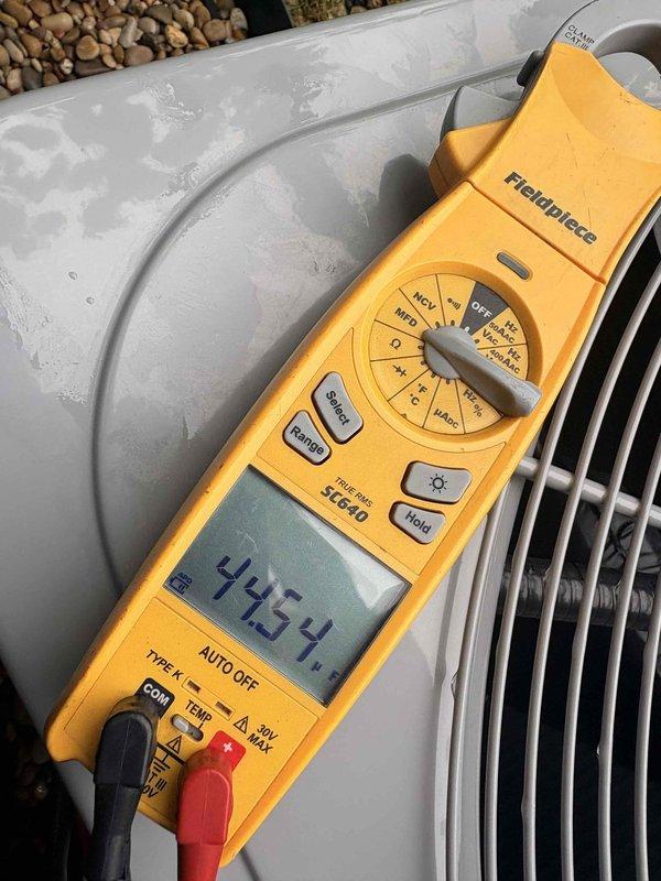 Completed scheduled cooling maintenance on outdoor condensing unit. Performed electrical diagnostics using digital multimeter, recording compressor amperage draw of 4.254 amps and system voltage reading of 433 volts. Inspected capacitor, wiring connections, and condenser coil condition, confirming all components operating within normal parameters.
