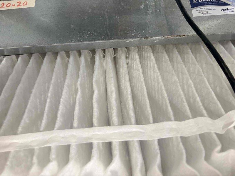 Completed scheduled cooling system maintenance inspection. Verified system operation with supply air temperature measuring 49°F at floor register, indicating proper cooling performance. Inspected and documented condition of Aprilaire 20x20 air filter showing normal dust accumulation with adequate airflow capacity remaining for continued operation.