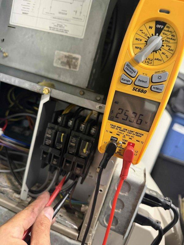 Responded to no cooling call with reported breaker tripping and dead thermostat on 10+ year old unit. Upon arrival, confirmed power issues and performed diagnostic inspection of HVAC system. Opened air handler compartment and found blower assembly with significant dirt and dust accumulation, indicating lack of regular maintenance. Inspected electrical components including capacitor, wiring connections, and associated hardware within the unit. Proceeded to main electrical panel and tested amperage draw, recording 23.36 amps on the affected circuit using clamp meter to verify electrical load and identify potential overcurrent condition causing breaker trips. Documented system condition with photos showing contaminated blower wheel and electrical measurements. Advised customer of diagnostic findings and discussed repair options for aging equipment experiencing electrical and operational failures.