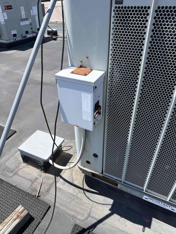 Performed diagnostic assessment on rooftop HVAC unit serving Room H-107 for no cooling complaint. Documented equipment model information and photographed unit configuration including electrical disconnect and control components. Diagnostic findings compiled for formal repair estimate pending customer approval before proceeding with additional work.