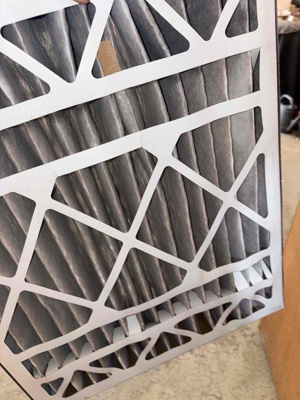 Completed first cooling maintenance service for 2026 season on residential HVAC system. Inspected outdoor condenser unit, noting weathering and oxidation on top surface and fan guard, with unit operational and fan assembly functioning properly. Documented air filter condition showing dust accumulation and discoloration on pleated media, indicating filters are due for replacement to maintain optimal airflow and system efficiency.