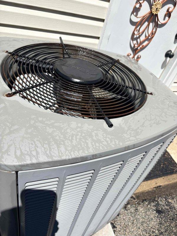 Completed first cooling maintenance service for 2026 season on residential HVAC system. Inspected outdoor condenser unit, noting weathering and oxidation on top surface and fan guard, with unit operational and fan assembly functioning properly. Documented air filter condition showing dust accumulation and discoloration on pleated media, indicating filters are due for replacement to maintain optimal airflow and system efficiency.