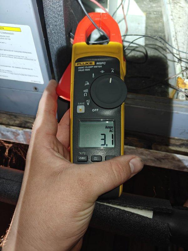 Performed comprehensive tune-up on 5-ton Trane air conditioning system with SpacePak indoor unit. Measured and recorded compressor amperage at 3.1 amps AC using clamp meter to verify proper electrical operation. Conducted system diagnostics and performance testing at return air grille to ensure optimal airflow and cooling efficiency.