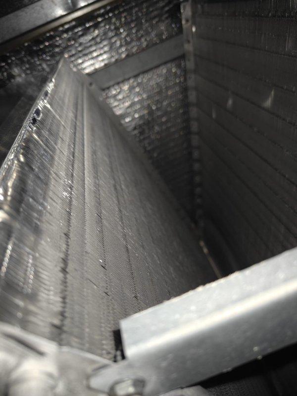Completed comprehensive cooling maintenance on two HVAC systems. Performed thorough inspection of air handling units, including examination of perforated metal housing panels, internal components, and structural integrity of both systems. Inspected ventilation grilles and multi-layer filtration systems, confirming proper airflow through angled slats and mesh screening. All components found to be in good operating condition with no visible corrosion, damage, or debris accumulation. Systems tested and operating within normal parameters.