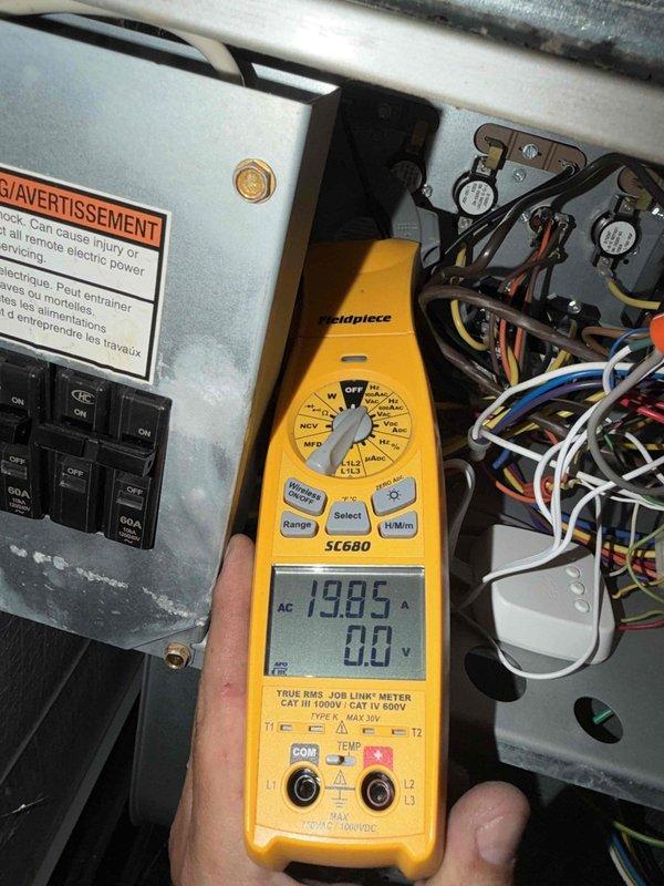Completed diagnostic evaluation of HVAC electrical system and prepared for customer-provided thermostat installation. Performed comprehensive electrical measurements using clamp meter, recording amperage draws of 19.85A and 203A at various points in the system to verify proper circuit loading and equipment operation. Inspected electrical panel wiring connections, contactors, and control circuits to assess compatibility requirements for new thermostat integration. Provided onsite pricing consultation for thermostat installation service.