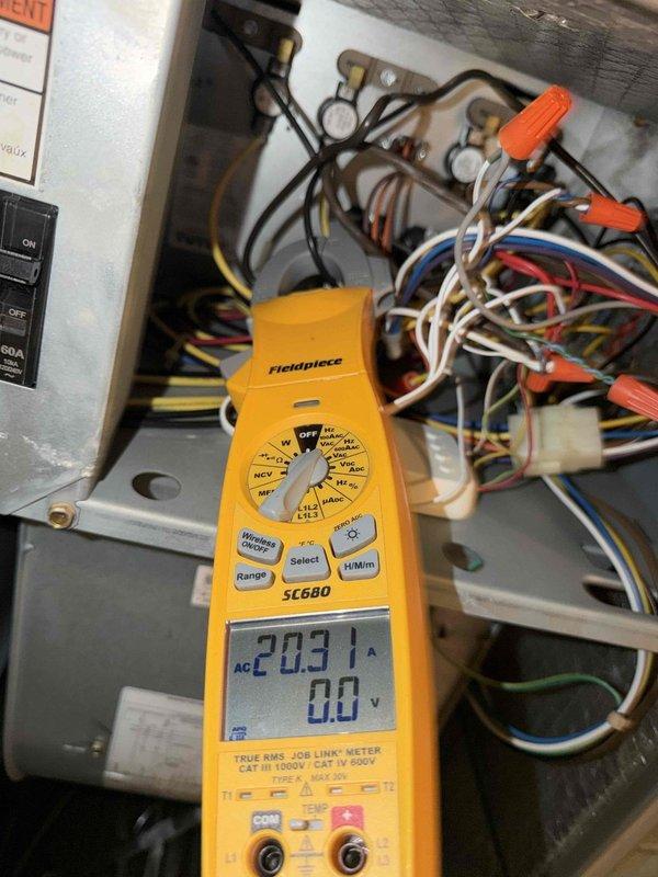 Completed diagnostic evaluation of HVAC electrical system and prepared for customer-provided thermostat installation. Performed comprehensive electrical measurements using clamp meter, recording amperage draws of 19.85A and 203A at various points in the system to verify proper circuit loading and equipment operation. Inspected electrical panel wiring connections, contactors, and control circuits to assess compatibility requirements for new thermostat integration. Provided onsite pricing consultation for thermostat installation service.