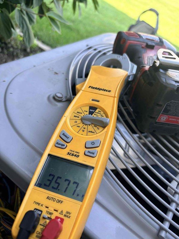 Completed comprehensive 2026 cooling maintenance on residential air conditioning system. Performed moisture meter diagnostics on ductwork and insulation components, recording readings of 505.5 to verify proper system integrity and identify potential condensation issues. Conducted electrical diagnostics on outdoor condenser unit using digital multimeter, measuring voltage at 3677, confirming proper power supply and component operation within manufacturer specifications.