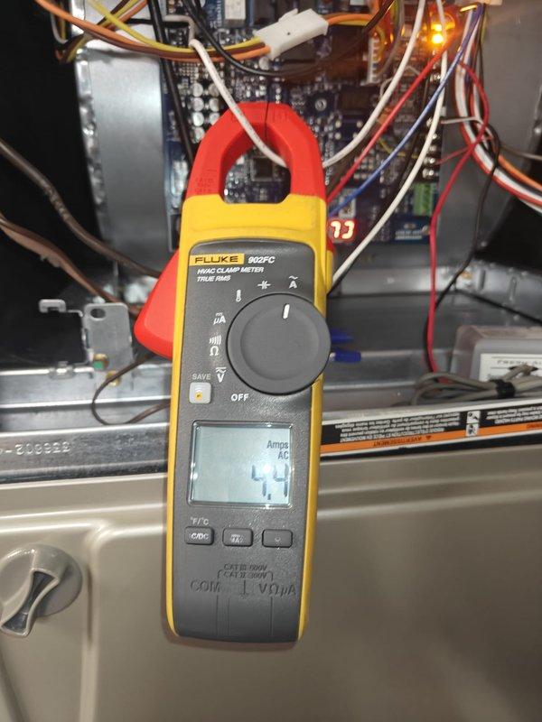Completed cooling system tune-up and maintenance inspection. Performed amperage readings on system components using clamp meter, recording compressor draw at 4.4 amps and blower motor current at 1.1 amps, both within manufacturer specifications. Inspected electrical connections, control board, and wiring harnesses for proper operation and secure terminations. System operating normally with all measurements indicating proper function.