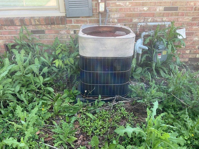 Completed comprehensive estimate for full HVAC system replacement at residential property. Assessed existing Lennox outdoor condensing unit with significant vegetation overgrowth obstructing airflow and indoor air handling unit with green-painted cabinet installed in utility space with connected ductwork. Documented current system conditions including outdoor unit surrounded by dense weeds and indoor equipment configuration to provide replacement recommendations for complete heating and cooling system upgrade.