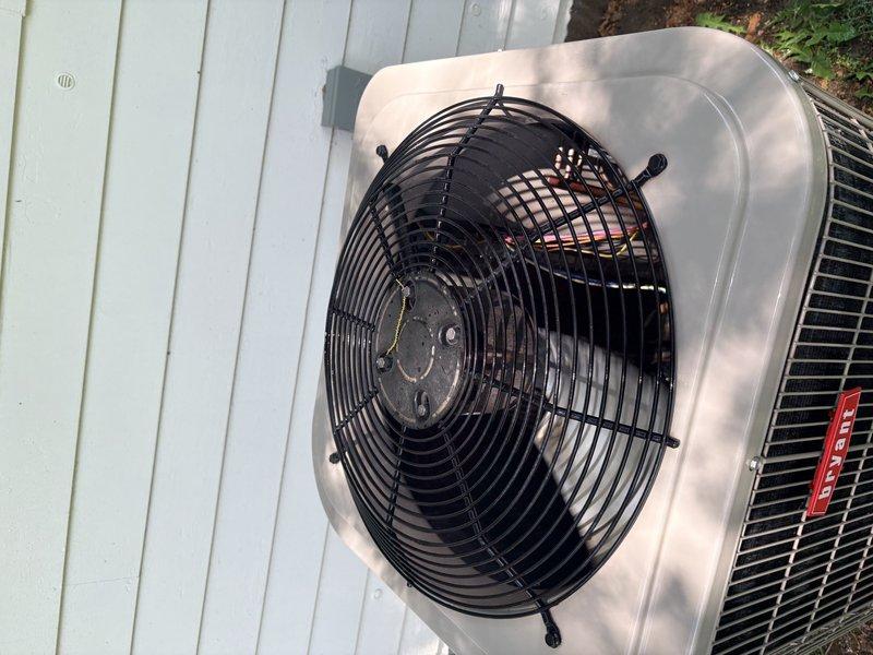Completed HVAC maintenance inspection on residential heating and cooling system. Verified indoor air handler operation and measured supply air temperature at 61°F at the unit. Inspected outdoor condensing unit, confirmed fan motor operation, and verified condenser coil condition with protective grille intact and functional.