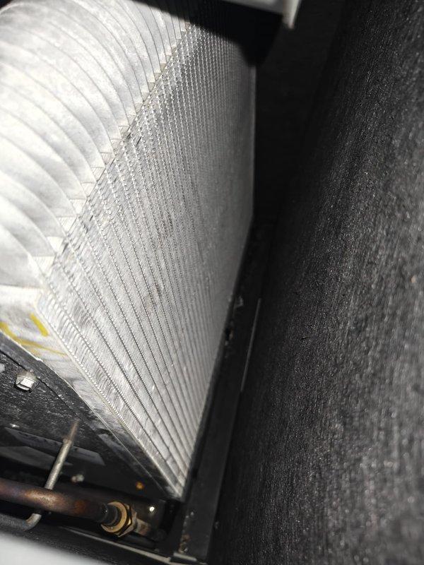 Completed first cooling season maintenance on residential HVAC system. Performed comprehensive inspection of evaporator coil, noting minor dust accumulation on aluminum fins but overall good condition with no significant debris buildup or damage to coil assembly. Tested system capacitance using calibration-grade meter, recording 40.9 µF reading to verify proper electrical component operation and ensure optimal compressor performance for the cooling season.