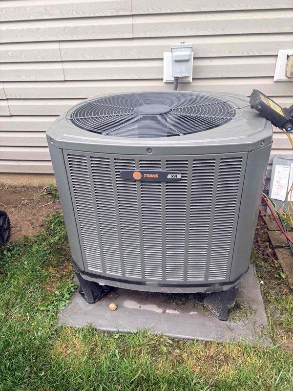 Responded to no cooling complaint on Trane XR16 condenser unit with no power, noise, or unusual odors reported. Upon arrival, performed diagnostic evaluation of outdoor unit and measured system temperatures using digital thermometer. Verified unit specifications, checked electrical connections, and tested condenser operation with diagnostic equipment. System restored to proper cooling operation and left running normally.