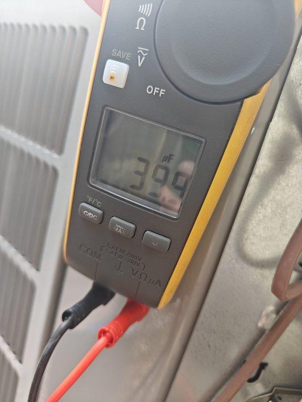 Completed comprehensive tune-up on heat pump system, including inspection of control board and electrical connections within the unit housing. Performed capacitance testing using digital multimeter, measuring 390 nF on system capacitor to verify proper operation. All components inspected and found operating within normal parameters.