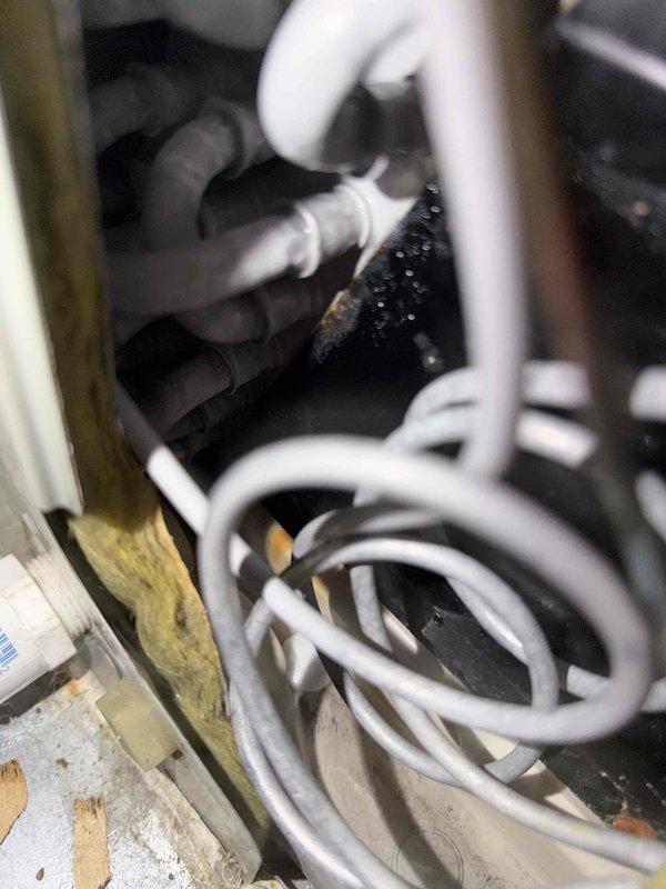 Completed comprehensive cooling system maintenance inspection on residential HVAC unit. Performed visual inspection of air handler interior components including refrigerant lines, condensate drain system, and insulation integrity, noting normal moisture accumulation on evaporator coil surfaces. Verified system airflow performance at supply register, measuring 50.7 CFM output temperature, confirming proper cooling delivery to conditioned space.
