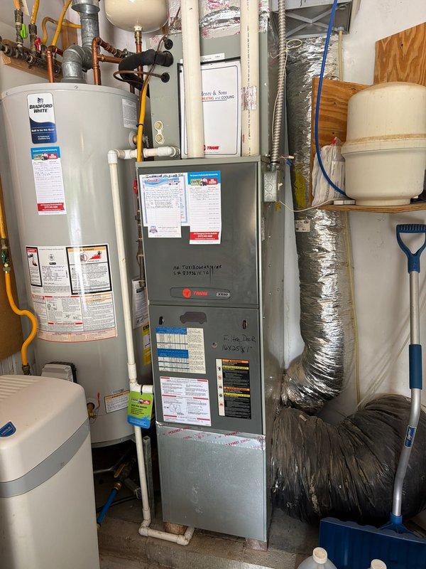 Completed comprehensive AC tune-up on outdoor condensing unit and indoor air handler system. Performed visual inspection of electrical components including capacitor, contactor, and relay connections; all wiring and terminals found to be secure with minor age-related weathering noted. Cleaned debris and insulation material from base of outdoor unit. Verified proper operation of compressor and associated electrical components. Inspected indoor Trane furnace and connected ductwork; confirmed all equipment labels and specifications are visible and intact. System tested and operating within normal parameters at time of service completion.