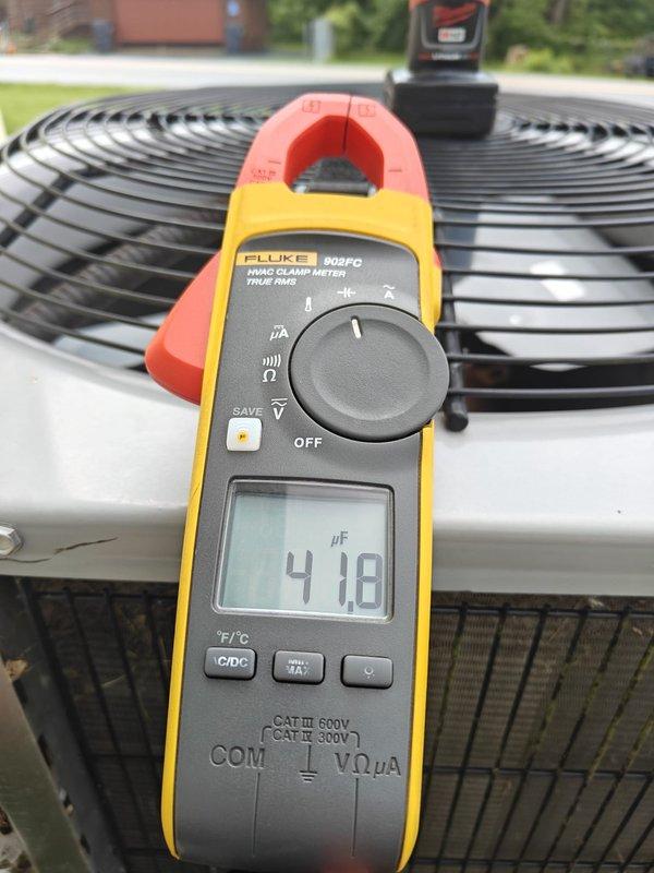 Performed comprehensive AC tune-up on residential air conditioning system. Conducted electrical diagnostics using digital clamp meter, measuring capacitance readings of 4.18 μF and 7.1 μF on system components to verify proper operation. Completed standard preventive maintenance procedures on outdoor condenser unit to ensure optimal system performance for the cooling season.