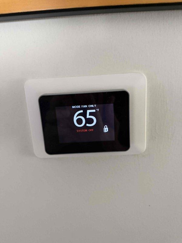 Responded to reported thermostat malfunction with erratic temperature display readings and sudden fluctuations between 74°F and 68°F. Upon arrival, performed diagnostic evaluation of thermostat operation and verified temperature accuracy using calibrated digital thermometer, which revealed a 7-degree variance between thermostat display reading and actual ambient temperature. Documented thermostat displaying inconsistent readings and confirmed system operational issues requiring thermostat calibration or replacement to restore proper HVAC system control.