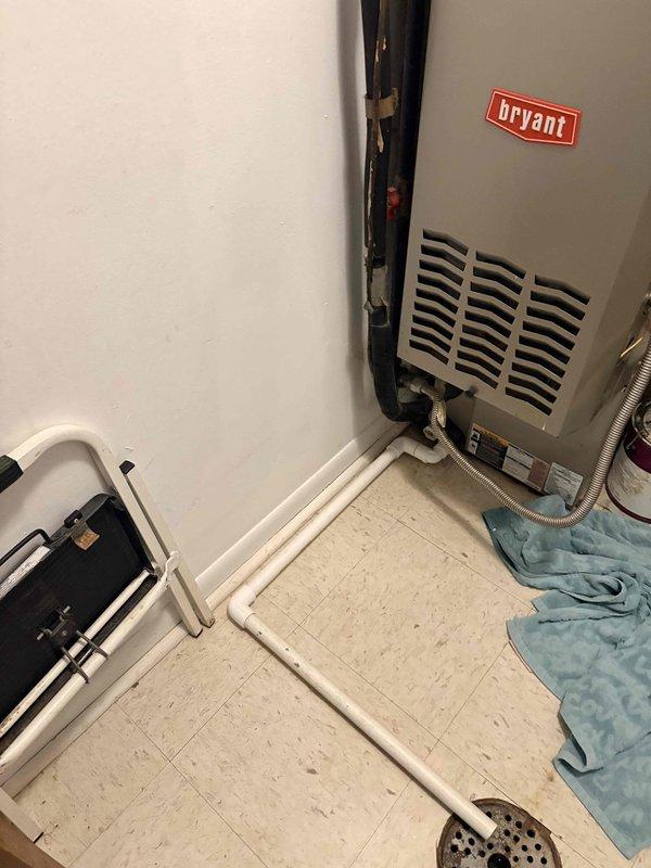 Responded to no heat call on 10+ year old Bryant furnace located in utility closet. Performed diagnostic inspection of unit, checked electrical connections, thermostat communication, and gas supply. Inspected heat exchanger, burner assembly, and blower motor operation. Documented current condition of equipment with photos showing unit installation, ductwork connections, and auxiliary components including condensate pump. Completed system evaluation and provided findings to property management for repair approval before proceeding with any necessary corrective work.