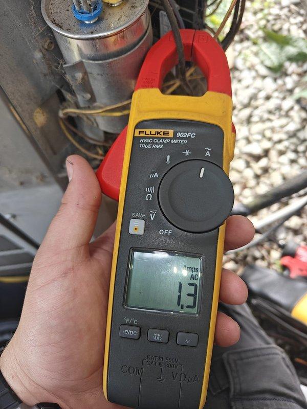 Completed comprehensive HVAC system tune-up including inspection of outdoor condensing unit and indoor air handler components. Performed electrical diagnostics using clamp meter, recording AC amperage draw of 1.3 amps on compressor circuit, which indicates normal operating parameters. Verified proper operation of refrigerant valves, inspected all electrical connections and wiring, and confirmed system access panels are secure and functioning correctly.