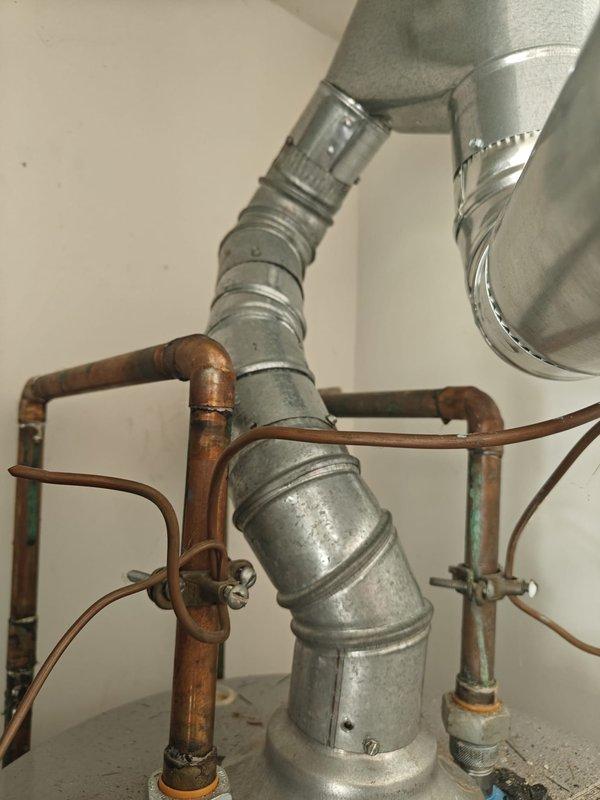 Completed previously quoted repairs on water heater system. Inspected and evaluated capacitor condition, provided pricing for replacement as requested, and proceeded with capacitor replacement upon approval. Verified proper operation of copper piping connections, shut-off valves, and galvanized vent pipe assembly to ensure system functionality and safety compliance.