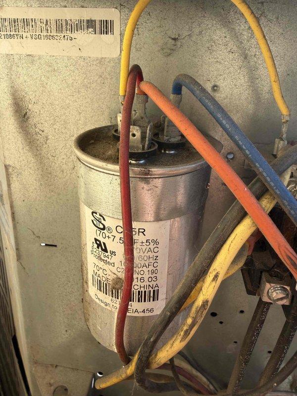 Responded to no cooling call on commercial HVAC unit. Upon inspection, diagnosed failed capacitor using multimeter which displayed abnormal readings. Replaced defective capacitor with new unit, verified proper electrical connections with multiple wire terminals, and confirmed system returned to normal operation.