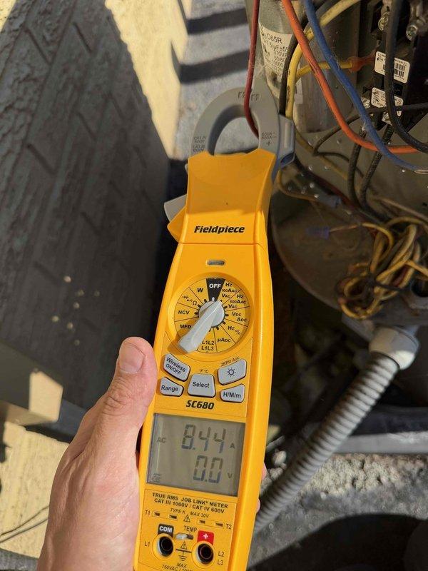 Responded to no cooling call on commercial HVAC unit. Upon inspection, diagnosed failed capacitor using multimeter which displayed abnormal readings. Replaced defective capacitor with new unit, verified proper electrical connections with multiple wire terminals, and confirmed system returned to normal operation.