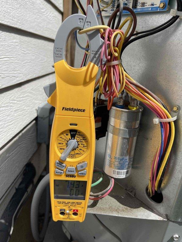 Responded to no cooling complaint on ground-level unit. Performed electrical diagnostics using clamp meter and identified failed dual-run capacitor (35/5 µF) preventing compressor and condenser fan operation. Replaced capacitor, verified proper amperage draws on all components, and confirmed system cooling properly upon departure.