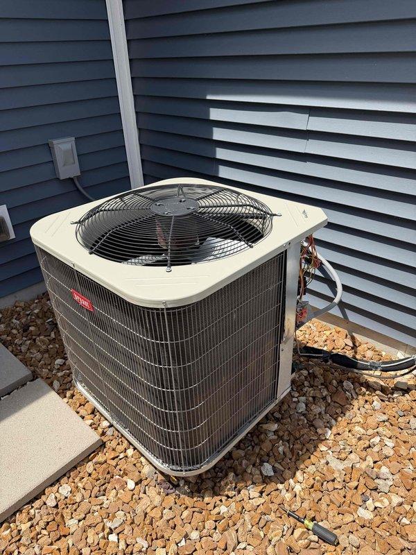 Responded to service call for outdoor condensing unit with reported fan failure. Upon arrival, inspected Goodman heat pump model BH14N0B0000GAAA (serial number 4918X74378) located on ground-level gravel pad against building exterior. Verified fan motor operation, checked electrical connections at unit, and confirmed proper power supply to condensing unit. Documented equipment condition and verified system returned to normal operation with fan running properly.
