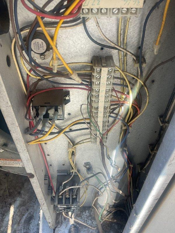 Replaced failed exterior kitchen condensing unit with new equipment to restore cooling capability. Disconnected and removed old cylindrical condenser unit, transferred electrical wiring and refrigerant lines, and installed replacement unit on existing gravel pad. Verified all electrical connections at control panel, tested system operation, and confirmed proper cooling function upon completion.