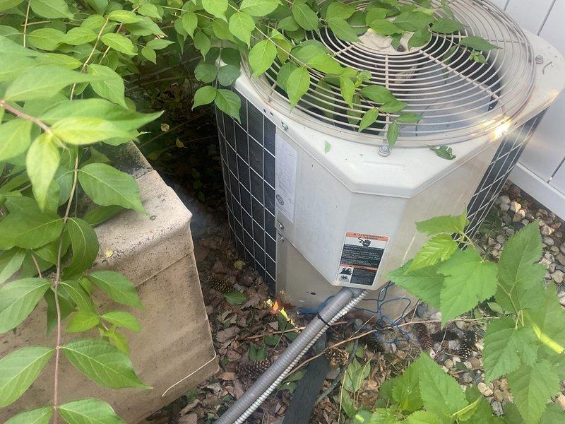 Replaced failed exterior kitchen condensing unit with new equipment to restore cooling capability. Disconnected and removed old cylindrical condenser unit, transferred electrical wiring and refrigerant lines, and installed replacement unit on existing gravel pad. Verified all electrical connections at control panel, tested system operation, and confirmed proper cooling function upon completion.