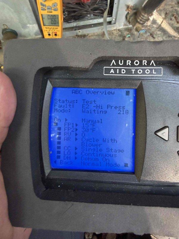 Responded to service call for non-operational geothermal heat pump located at pool area equipment pad. Upon arrival, performed diagnostic testing using Aurora AID diagnostic tool which indicated high pressure fault condition in the system. The geothermal unit, installed with Danfoss water filtration components and PVC piping configuration, showed fault status during testing mode. Documented existing equipment setup including electrical panel, water treatment system, and ground loop connections. Advised customer that repair work would be weather-dependent due to outdoor installation location and current conditions affecting safe service access.