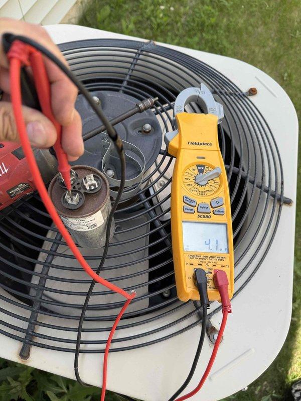 Responded to no cooling call on R410A system. Performed diagnostic testing using refrigerant manifold gauge to measure system pressures and temperatures. High side pressure reading of 347.7 PSIG and low side pressure of 118.7 PSIG indicated potential system issues. Superheat measurements of 19.6°F and 20.1°F were recorded on both lines. Saturation temperatures measured at 39.1°F on low side and 106.0°F on high side. Conducted electrical testing on condenser unit capacitor using multimeter, which displayed a reading of 4.1 microfarads. Based on diagnostic findings, provided customer with repair options and recommendations for restoring proper cooling operation to the system.