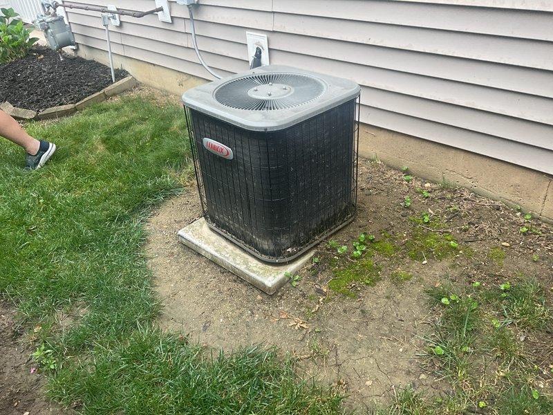 Conducted comprehensive site evaluation for complete HVAC system replacement, assessing existing Lennox outdoor condenser unit positioned on concrete pad with visible weathering and age-related deterioration. Evaluated current system configuration including electrical connections, refrigerant lines, and overall equipment condition to provide accurate replacement specifications. Additionally assessed water heater installation in utility space, documenting existing plumbing connections, copper piping, shut-off valves, and insulated tank configuration to determine feasibility of concurrent water heater replacement with new HVAC system installation.