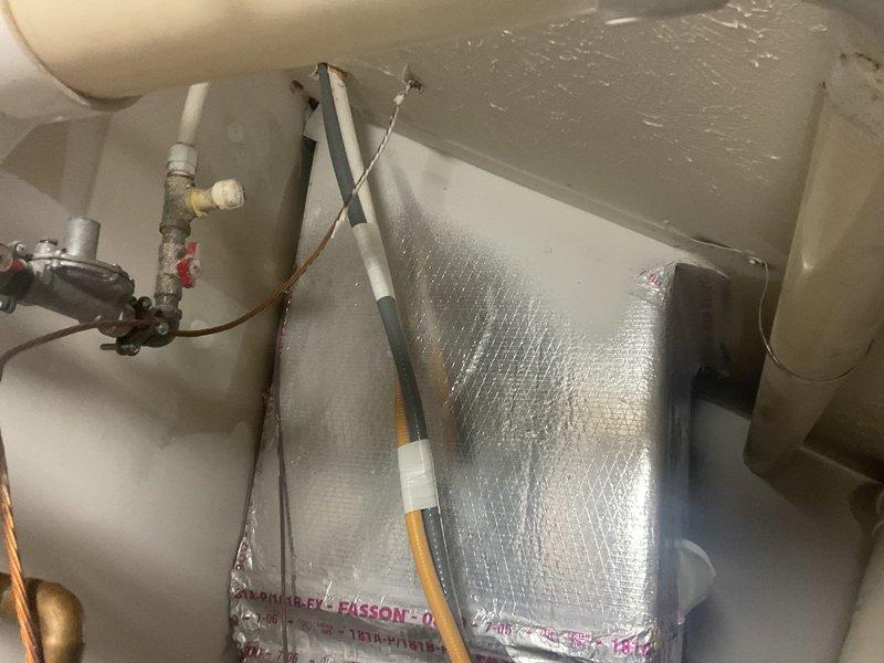Conducted comprehensive site evaluation for complete HVAC system replacement, assessing existing Lennox outdoor condenser unit positioned on concrete pad with visible weathering and age-related deterioration. Evaluated current system configuration including electrical connections, refrigerant lines, and overall equipment condition to provide accurate replacement specifications. Additionally assessed water heater installation in utility space, documenting existing plumbing connections, copper piping, shut-off valves, and insulated tank configuration to determine feasibility of concurrent water heater replacement with new HVAC system installation.