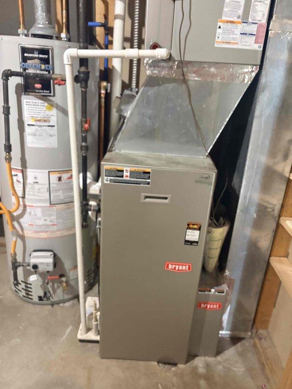 Completed pre-sale inspection of Bryant furnace and air conditioning system as requested. Performed comprehensive system evaluation of heating equipment in basement, inspecting furnace unit, ductwork connections, PVC venting system, and condensate drainage. Verified proper installation and connections to water heater venting. Conducted exterior AC unit diagnostics using digital multimeter to test electrical components and capacitor functionality. Inspected condenser unit wiring, connections, and overall system operation. Addressed concern regarding damaged vent pipe connected to water heater. Both heating and cooling systems evaluated for proper operation prior to home sale.