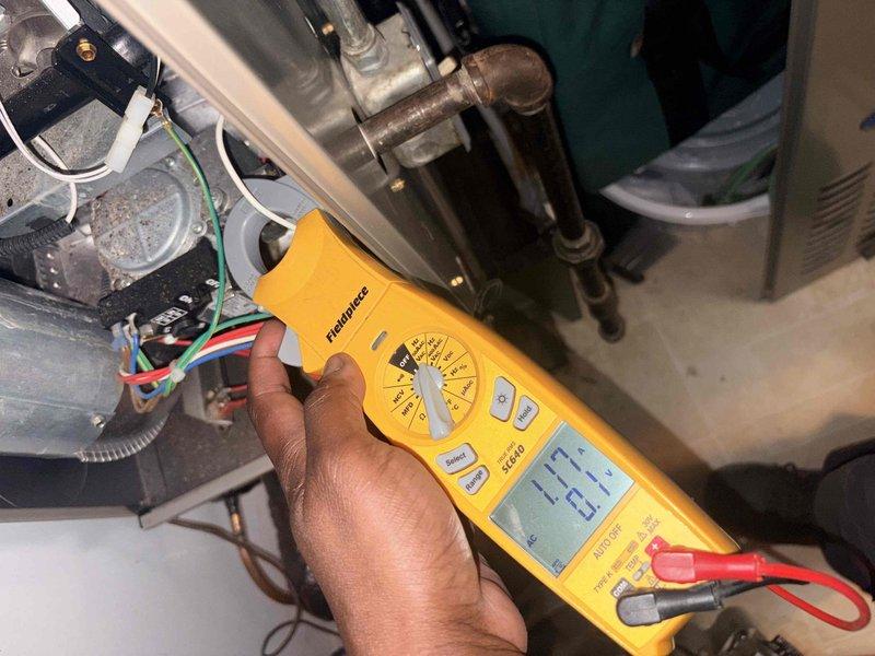 Performed annual cooling maintenance on Carrier air conditioning system and diagnosed inadequate cooling complaint. Installed 16x20x4 filter at indoor air handler and conducted comprehensive system inspection. Measured electrical parameters at indoor unit using digital multimeter, recording voltage reading of 23.7V during diagnostic testing. Inspected outdoor condenser unit positioned on concrete pad, verifying proper placement and clearance from landscaping. Evaluated condenser coil condition, refrigerant lines, and overall system operation to identify cooling deficiency cause and restore optimal performance.