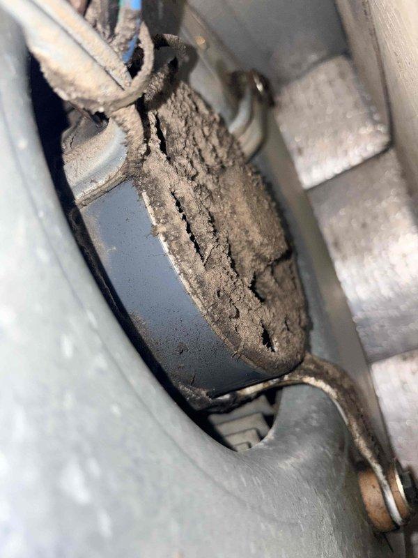 Responded to no cooling complaint on residential air conditioning system. Upon inspection, found evaporator coil frozen with ice buildup. Diagnosed contributing factors including severely restricted airflow due to excessive dust and debris accumulation on blower components and internal surfaces. Measured refrigerant pressures at condensing unit showing abnormal readings consistent with reduced airflow conditions. Identified heavily soiled capacitor and surrounding components indicating extended period without maintenance. Recommended system cleaning, filter replacement, and follow-up evaluation after thaw to determine if additional refrigerant circuit issues exist.