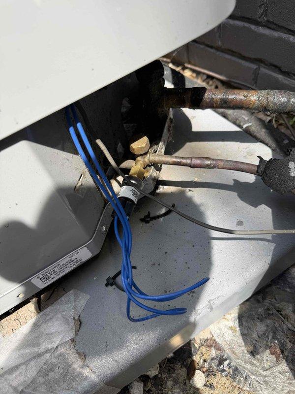 Responded to no cooling call for aging warehouse unit. Upon arrival, found evaporator coil completely frozen over. Performed diagnostic inspection and identified restricted airflow as primary cause. Instructed customer to power off cooling mode and switch system to fan-only operation to allow coil to thaw. Inspected air filter and found MERV 8 filter with significant loading. Examined copper refrigerant lines and brass fittings, noting oxidation and patina consistent with unit age. Documented system condition with photographs showing frozen coil components and aged piping. Recommended customer schedule follow-up appointment after complete thaw to determine if issue is caused by low refrigerant charge, failed blower motor capacitor, or other underlying mechanical failure requiring repair.