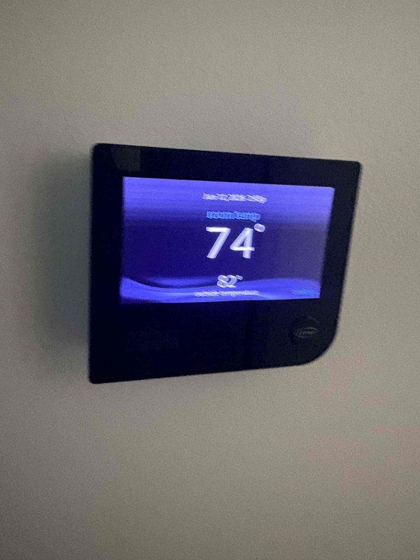 Completed 2026 cooling maintenance inspection and addressed condensation issue on HVAC unit. Inspected air filter, which was found to be clean and properly installed in housing compartment. Verified thermostat operation with display reading 74 degrees and functioning correctly. Examined condensate drainage system and insulation on refrigerant lines to identify source of condensation concern. All system components operating within normal parameters at time of service.