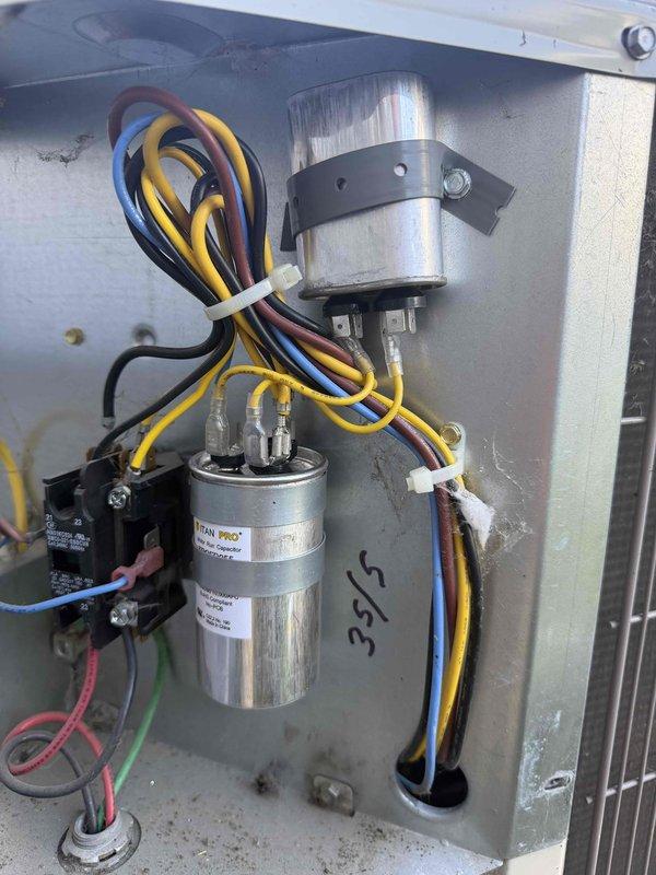 Responded to no cooling complaint on 10+ year old outdoor condensing unit where indoor temperature was reaching 80's. Upon inspection, diagnosed failed run capacitor (TITAN PRO brand) in condensing unit, which was preventing compressor from operating efficiently. Replaced defective capacitor with new unit, verified proper electrical connections, tested system operation, and confirmed unit now cooling properly with temperature dropping to desired setpoint.