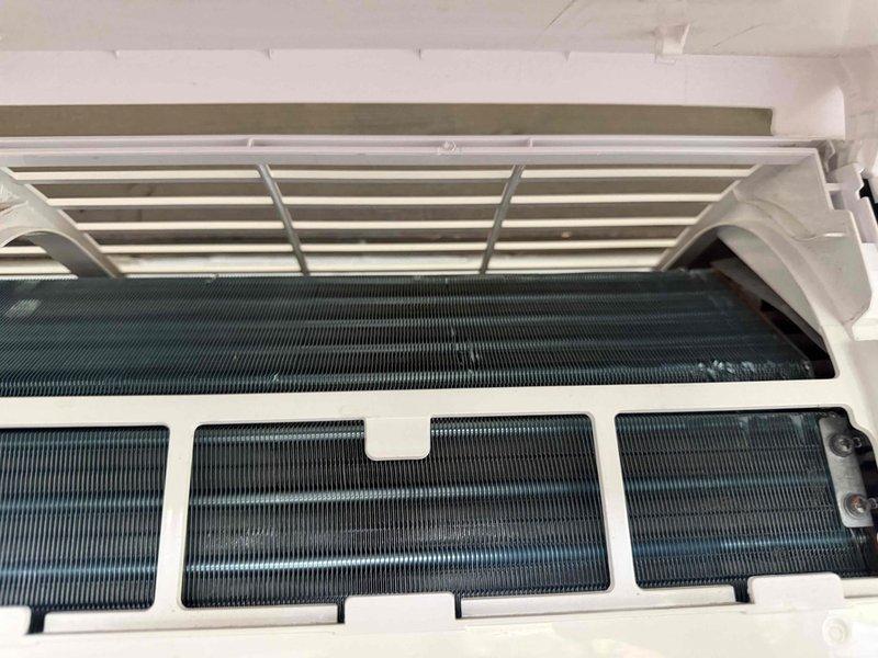 Responded to customer complaint regarding inadequate cooling performance on wall-mounted split system air conditioning unit. Upon arrival, opened and inspected the indoor evaporator unit, revealing accessible evaporator coil sections and filter panels. Visual inspection showed coils and internal components in maintained condition with no obvious debris accumulation or damage. Measured supply air temperature at 68.0°F using calibrated digital thermometer to establish baseline cooling performance. System appears operational with all mechanical components intact and properly positioned within the housing.