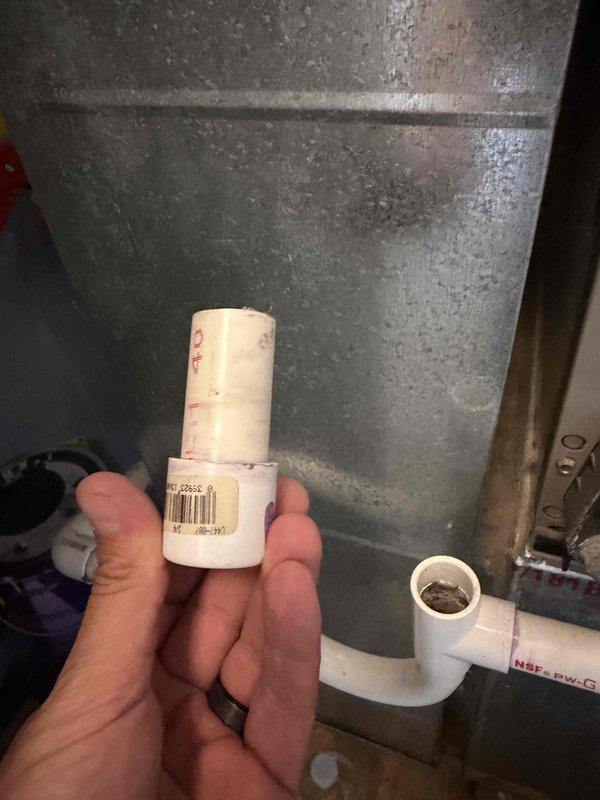 Completed comprehensive AC tune-up service including system inspection and filter replacement. Removed and replaced heavily soiled air filter that showed significant dust and debris accumulation, which was restricting airflow and reducing system efficiency. Inspected condensate drain line components and verified proper PVC pipe connections to ensure adequate drainage and prevent potential water damage.