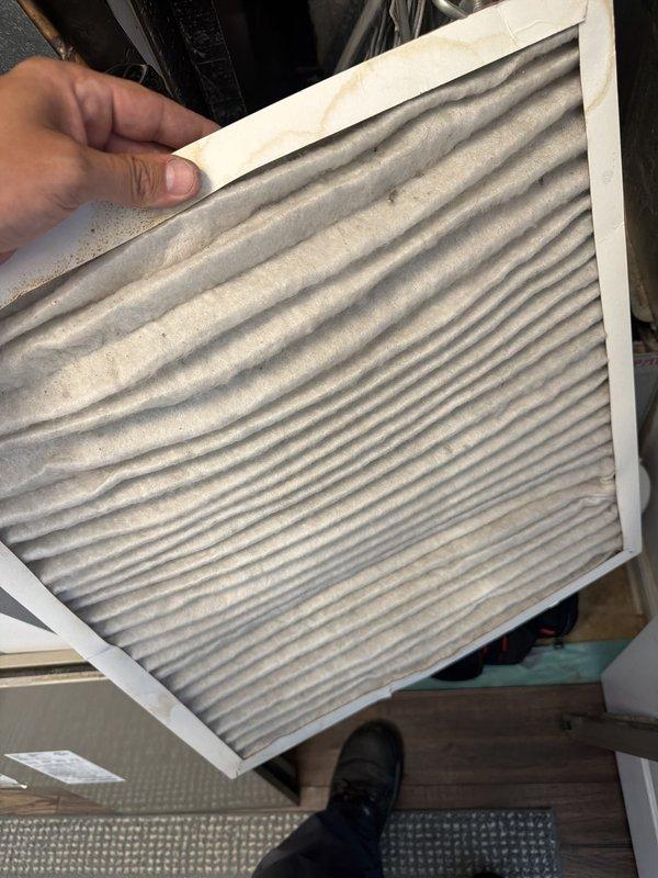 Completed comprehensive AC tune-up service including system inspection and filter replacement. Removed and replaced heavily soiled air filter that showed significant dust and debris accumulation, which was restricting airflow and reducing system efficiency. Inspected condensate drain line components and verified proper PVC pipe connections to ensure adequate drainage and prevent potential water damage.
