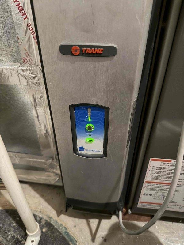 Completed 2026 cooling maintenance first service on two HVAC systems. Performed comprehensive maintenance including cleaning of electrostatic filters as requested, inspected Trane unit with CleanEffects air filtration system showing proper operational status on digital display, and documented significant contamination and deterioration of ductwork insulation with visible mold or dirt accumulation requiring future attention. All routine maintenance tasks completed per service protocol, systems operational, photographic documentation captured for service records.