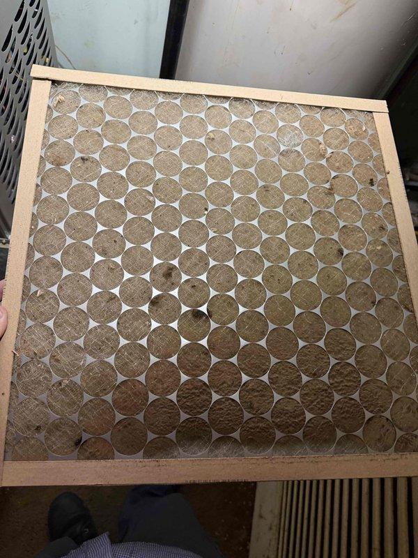 Responded to no cooling complaint on system with furnace replacement completed in November. Previous contractor indicated possible control board failure with no signal being sent to outdoor unit. Upon arrival, discovered heavily soiled air filter with significant dust and debris accumulation restricting airflow throughout system. Filter media showed substantial discoloration and clogging across entire surface area, indicating extended period without replacement.

Inspected furnace control board and wiring connections. Verified all wire terminations secure at board including thermostat connections, outdoor unit control wiring, and power supply circuits. Control board displaying normal operation with no fault indicators present. Tested voltage output to outdoor unit and confirmed proper 24VAC signal being sent from board. Replaced severely restricted air filter with new filter to restore proper system airflow. Cycled system through cooling mode and verified outdoor unit receiving proper 