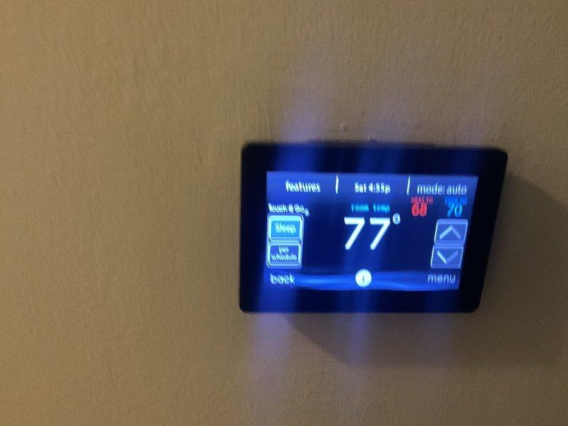 Conducted initial consultation with new customer for complete HVAC system replacement. Evaluated existing equipment including furnace and air handler unit in basement utility area, documented current programmable thermostat set to auto mode at 77°F, and assessed installation requirements for new system replacement.